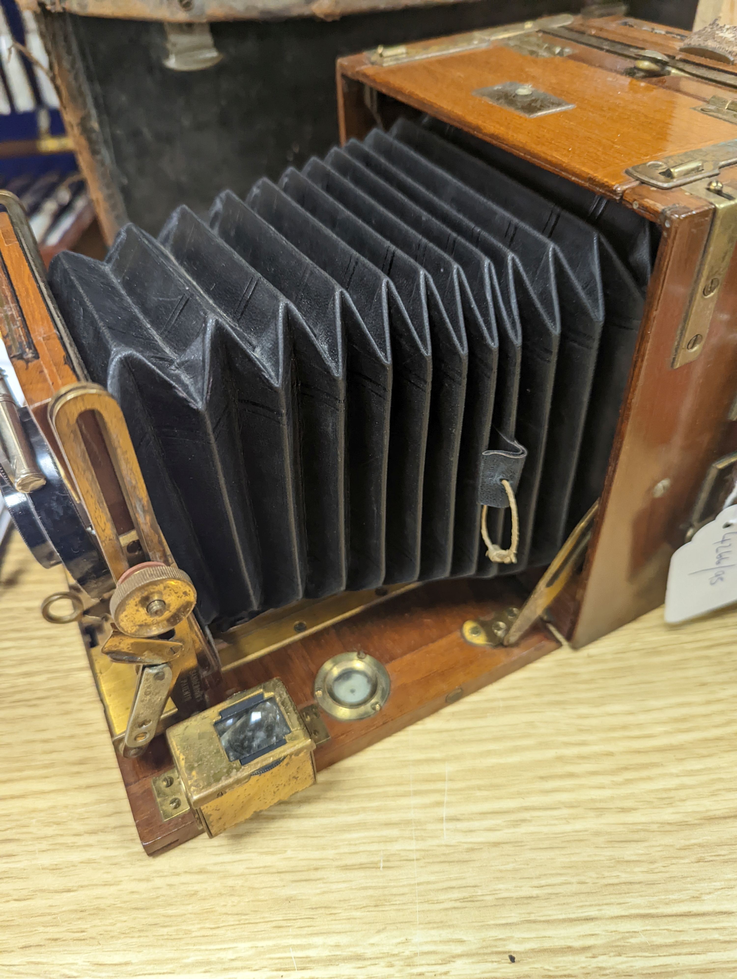 A Sanderson ‘Tropical Model’ plate camera, leather cased with various mahogany plate holders.